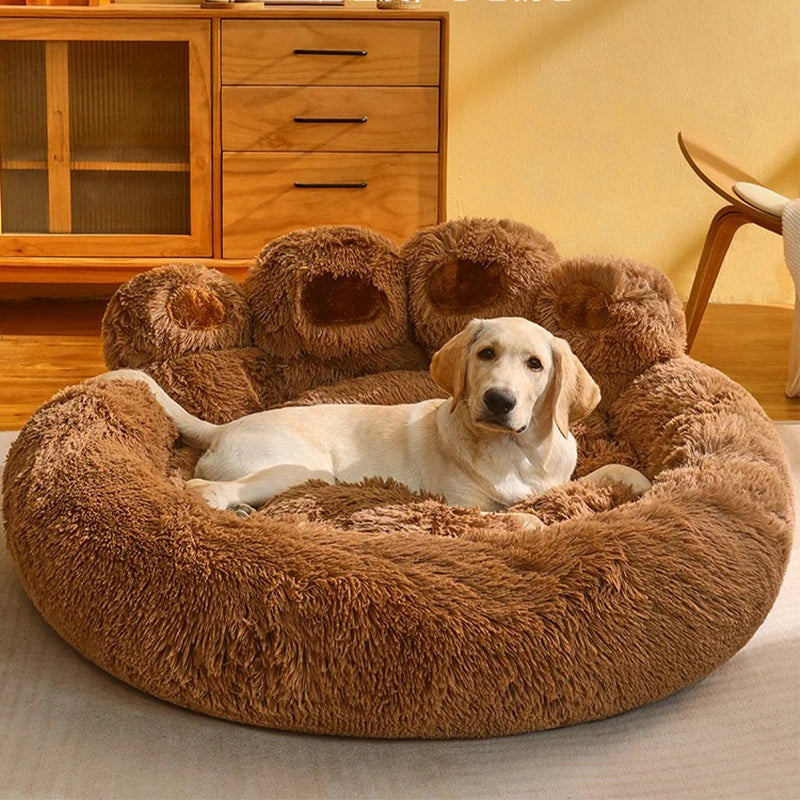 Dog lying on a fluffy brown pet bed in a cozy room.