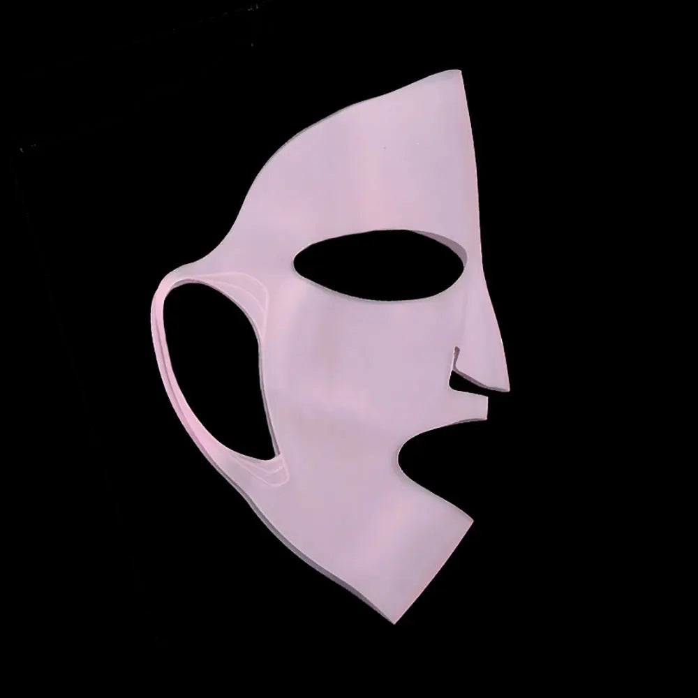 White mask with a black interior on a black background