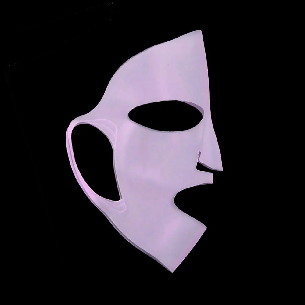 White mask with a black interior on a black background