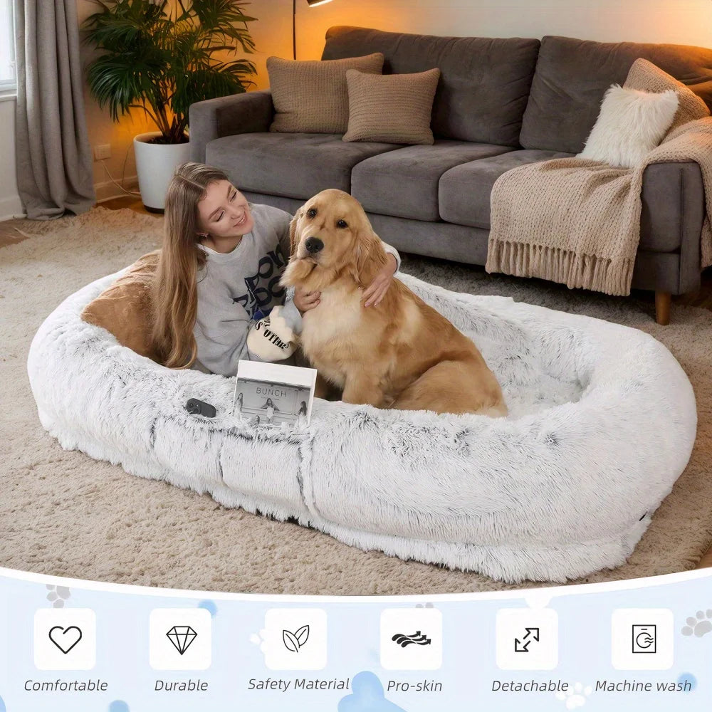 Woman sitting on a fluffy pet bed with a dog in a cozy living room.