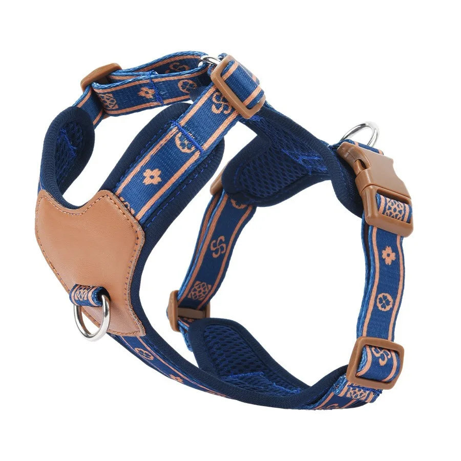 Blue dog harness with brown leather accents on a white background