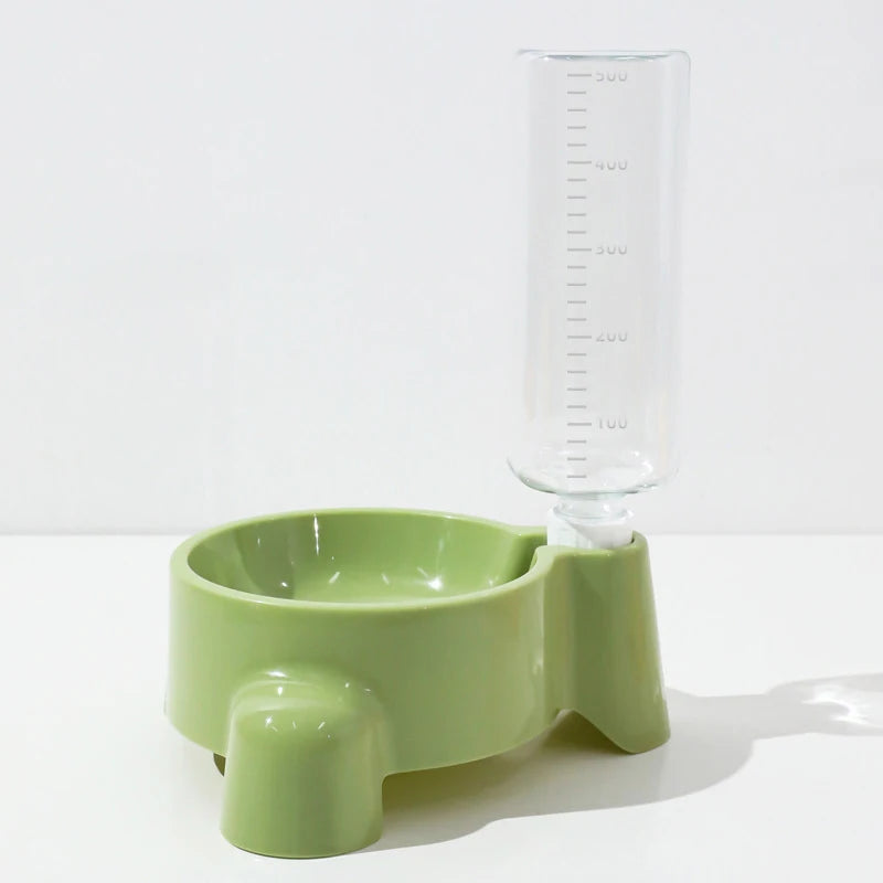 Green pet feeder with a clear water bottle attachment on a white background