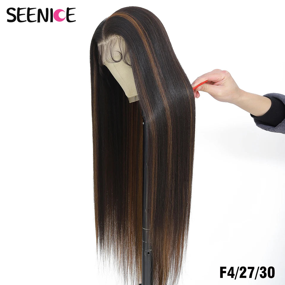 A long, straight wig with dark brown to black ombre highlights, displayed on a mannequin stand with a hand holding a section of the hair. The brand name 'SEENICE' is visible in the top left corner, and the text 'F4/27/30' is in the bottom right.