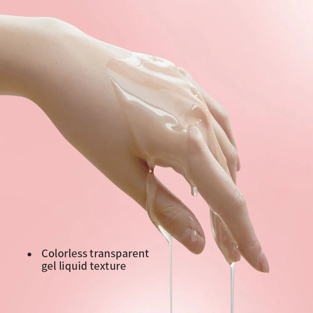 Hand holding colorless transparent gel liquid against a pink background