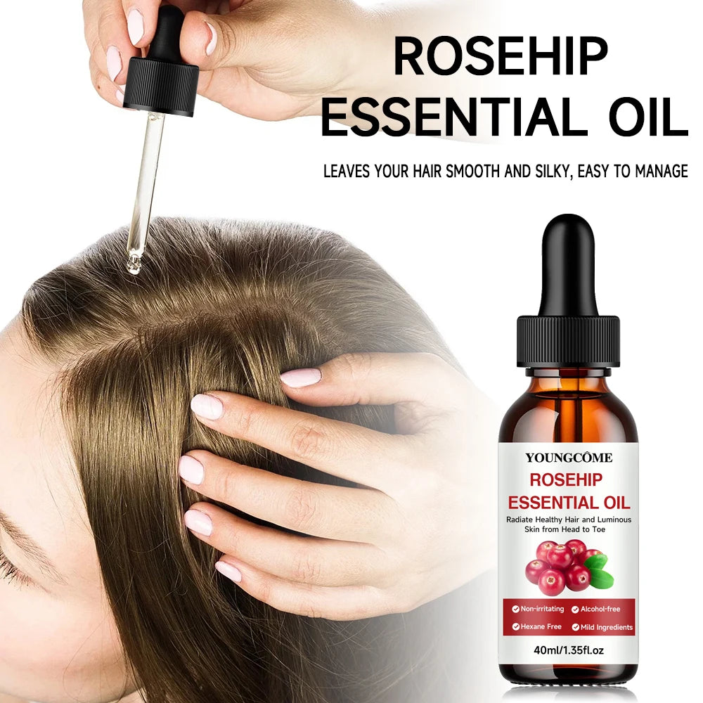 Person applying rosehip essential oil to hair with a dropper, next to a bottle of Youngcome rosehip essential oil.