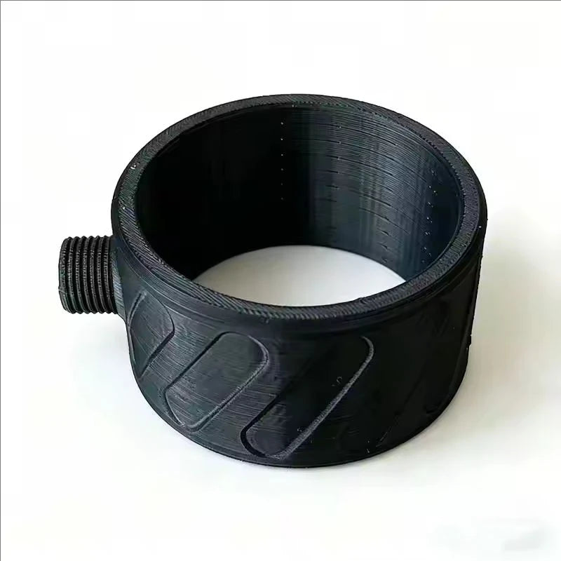 A black 3D-printed ring-shaped component with a threaded male connection on one side and textured grip patterns on the outside, shown on a plain white background.