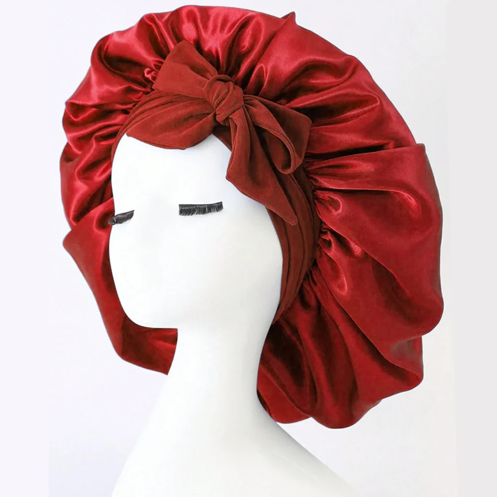Red satin bonnet on a mannequin head against a white background