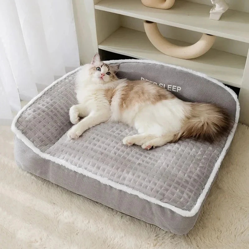 Cat lying on a gray pet bed with 'Deep Sleep' text in a cozy room.