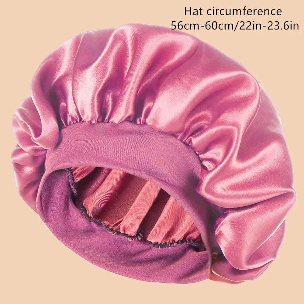 Pink satin bonnet on a beige background with text indicating circumference.