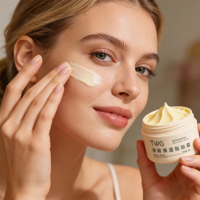 Woman applying cream to her face with a jar of TWG cream in the background