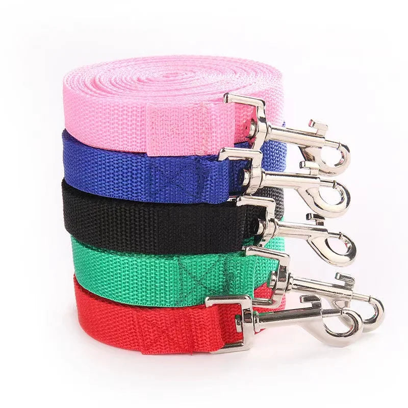 Set of colorful dog leashes with metal clips on a white background