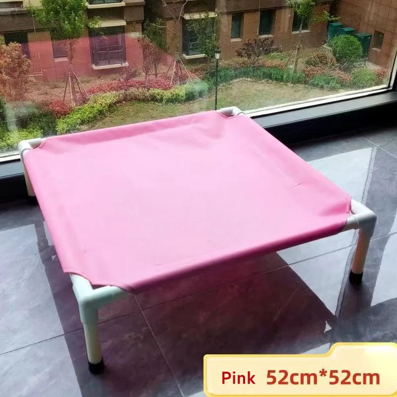 Pink pet bed on a stand in front of a window with a garden view