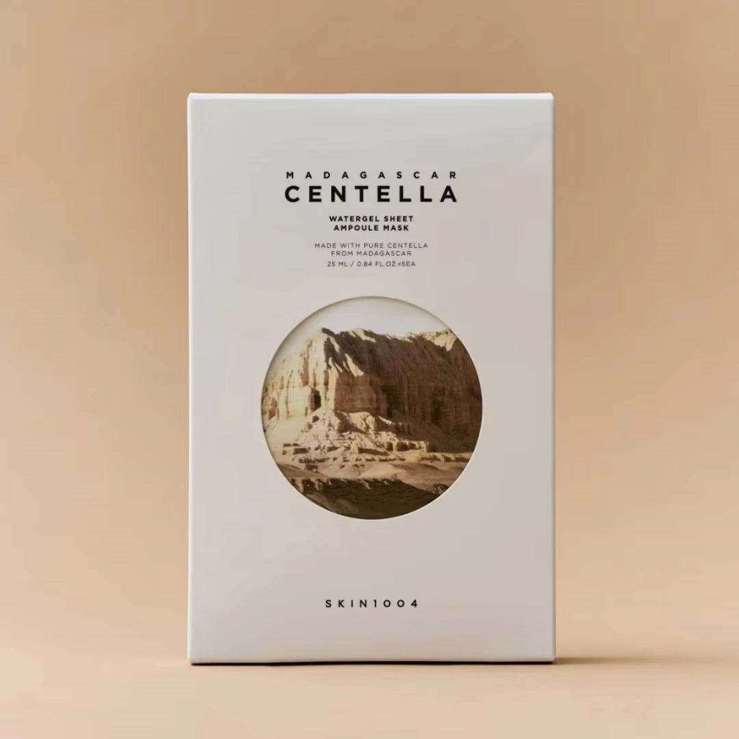 A white rectangular box of SKIN1004 Hadabargan Centella Watergel Sheet Ampoule Mask, featuring a circular sepia-toned illustration of a coastal landscape on the front, set against a solid beige background.