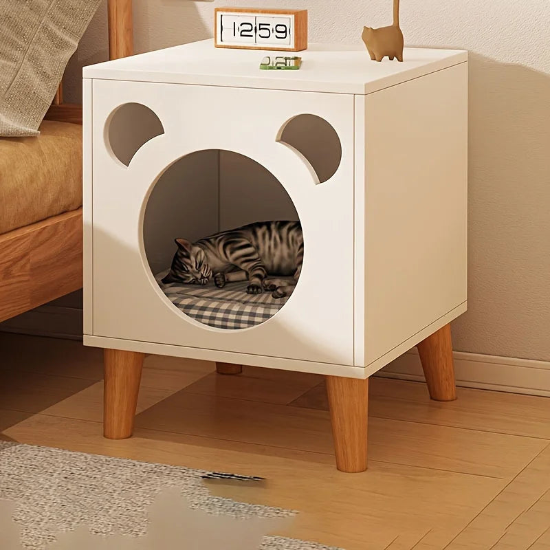 Cat bed designed like a bear with a cat inside, placed on a wooden floor.