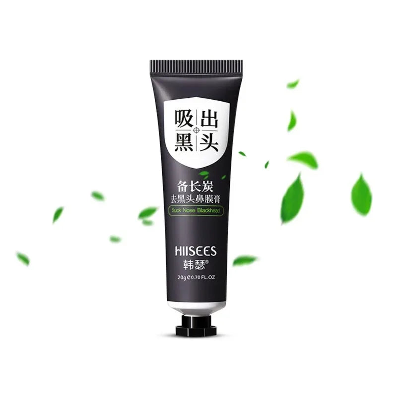 Black tube of skincare product with green leaves on a white background