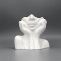 White ceramic bust sculpture on a gray background
