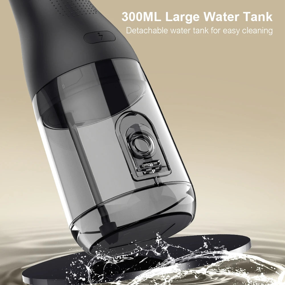 Black handheld vacuum cleaner with detachable water tank on a beige background