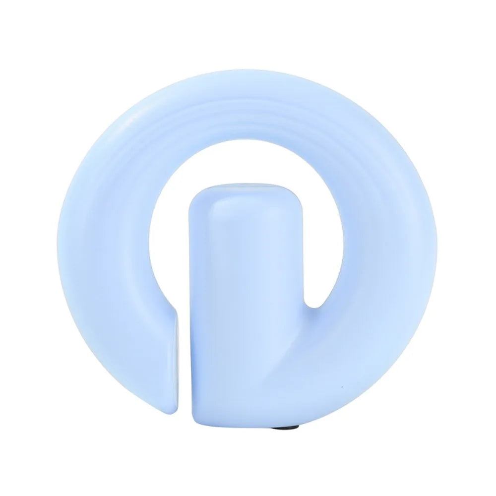A light blue silicone baby teething ring with a central handle, shown on a plain white background.