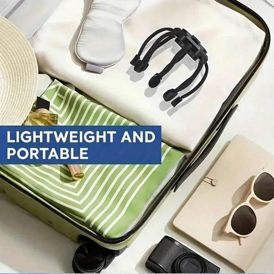 Open suitcase with travel items including a hat, camera, sunglasses, and folded clothes on a white background.