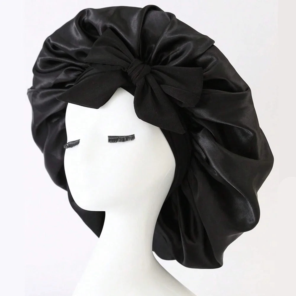 Black satin head wrap on a mannequin head against a white background
