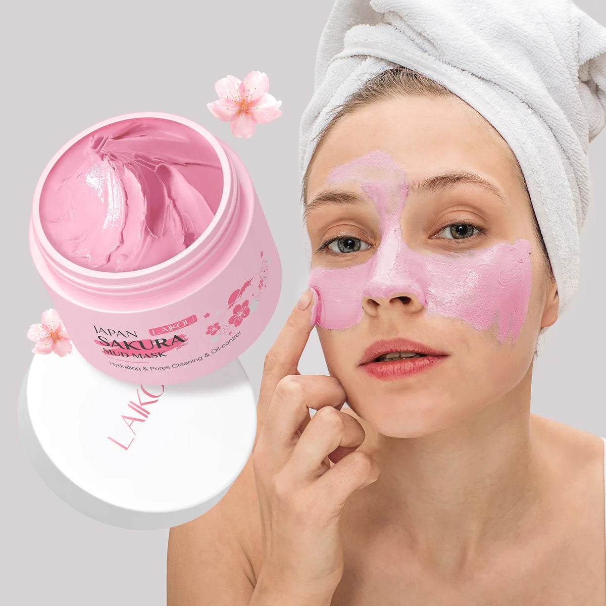 Woman applying pink facial mask with 'Japan Sakura' product in the foreground