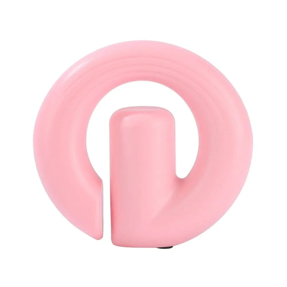 A light pink silicone safety ring designed for babies, toddlers, or pets, featuring a central cylindrical handle, shown on a solid white background.