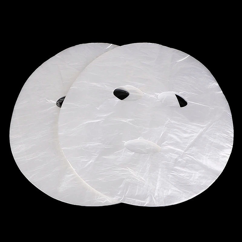 Two white circular objects with textured surface and black centers on a black background