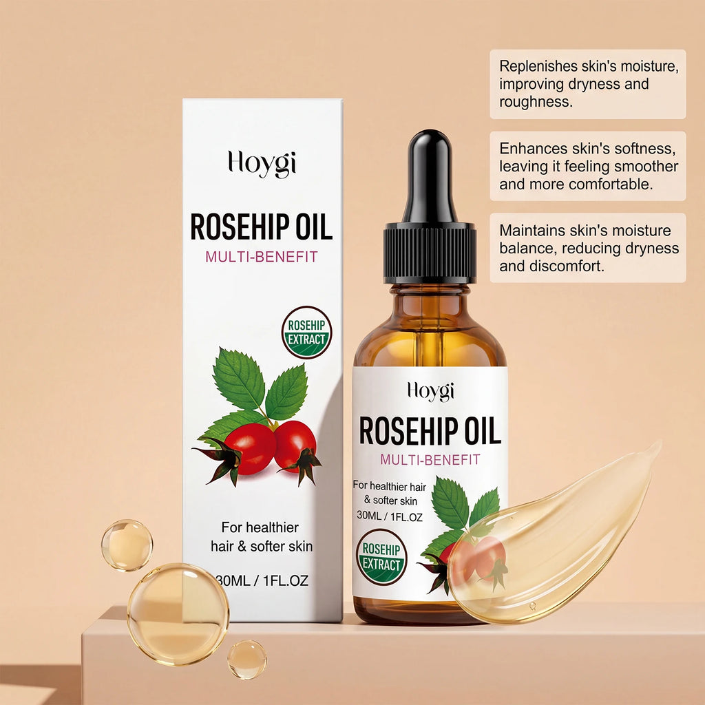 Hoygi Rosehip Oil Multi-Benefit bottle and packaging box displayed on a beige background with decorative droplets and a translucent leaf. The amber glass bottle has a black dropper cap and a white label with green leaves and red rosehip illustrations.