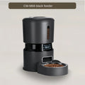 Black pet feeder with digital display on a beige background