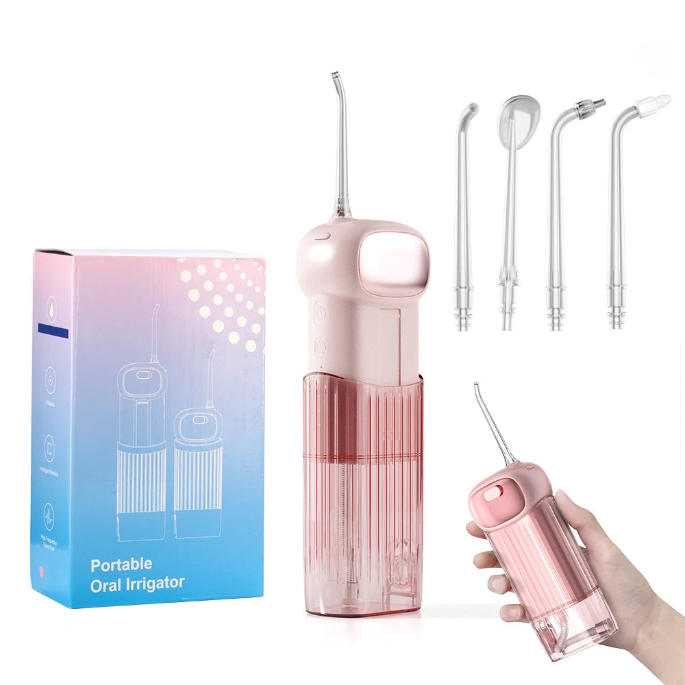 Pink portable oral irrigator with packaging and additional nozzles on a white background
