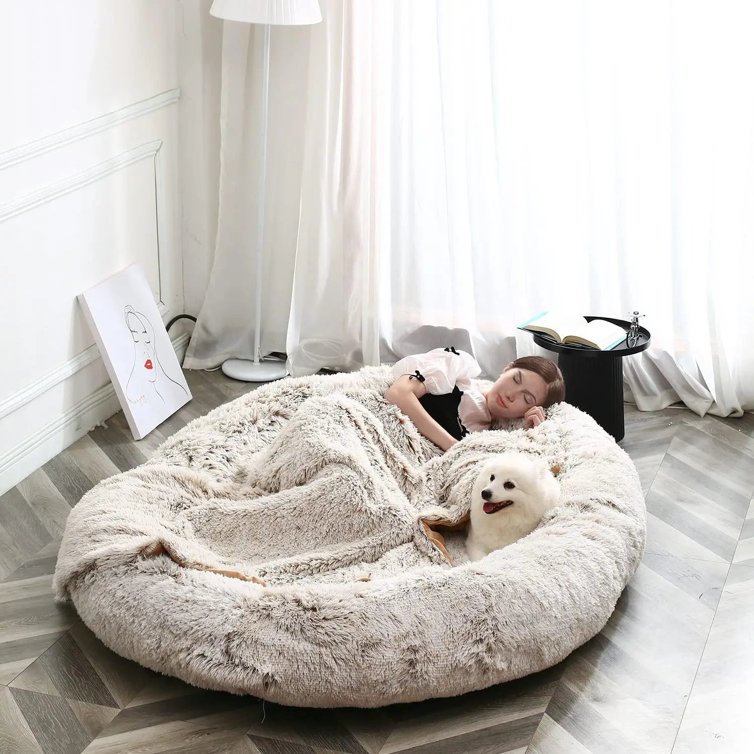 Person lying on a fluffy pet bed with a dog in a modern room.