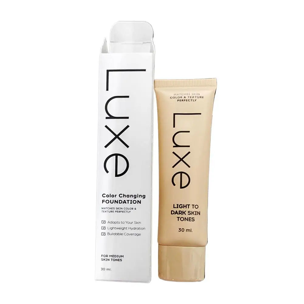 Luxe Color Changing Foundation in a 30 ml squeeze tube next to its white cardboard packaging box, shown on a plain white background.