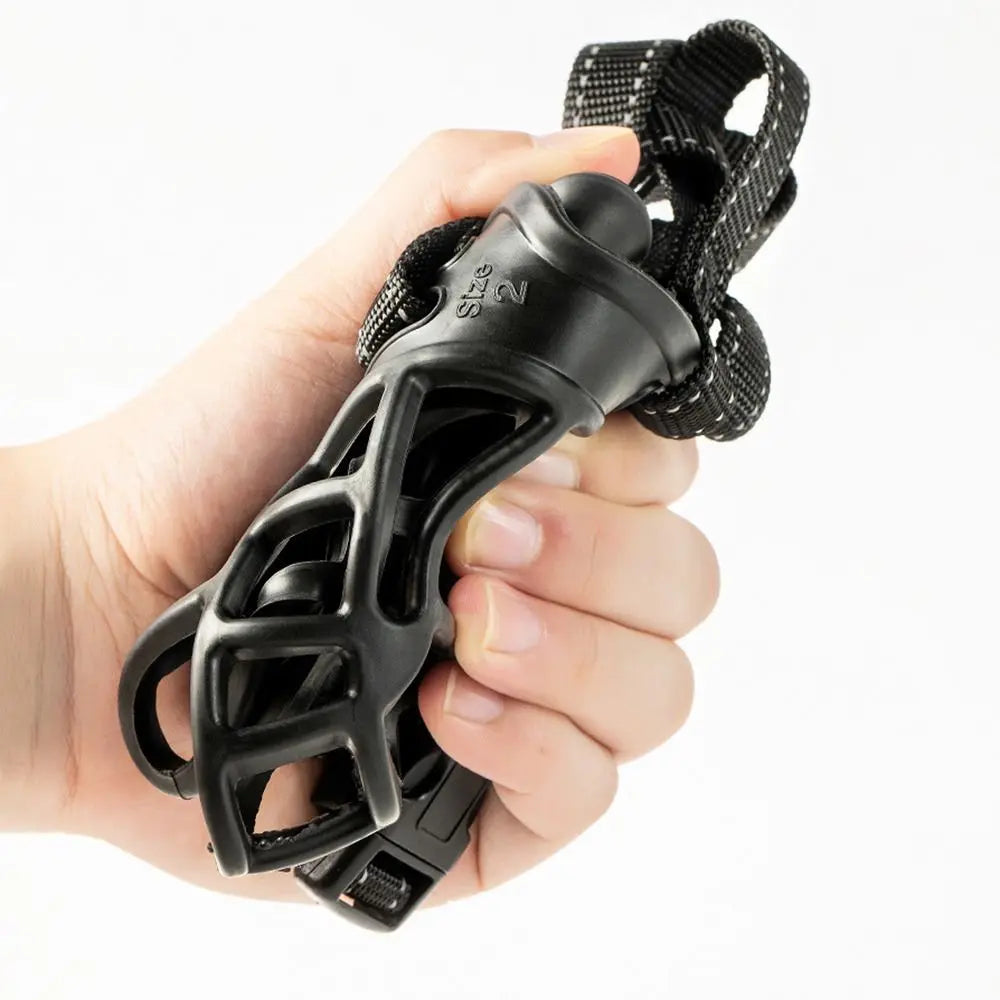 Black knuckleduster held in a hand against a white background