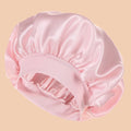 Pink satin bonnet on a beige background