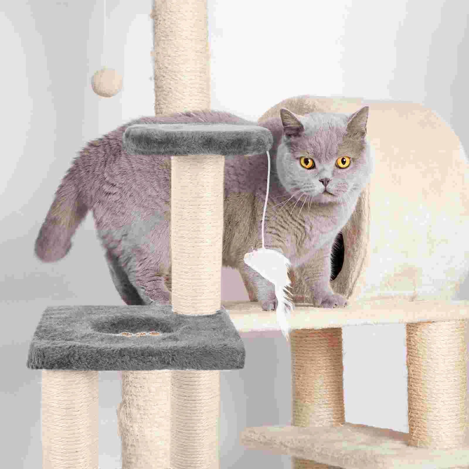 Cat playing with a toy on a cat tree