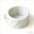 A white plastic ring-shaped component with a threaded male connector on one side and a ribbed outer surface, photographed on a plain white background.