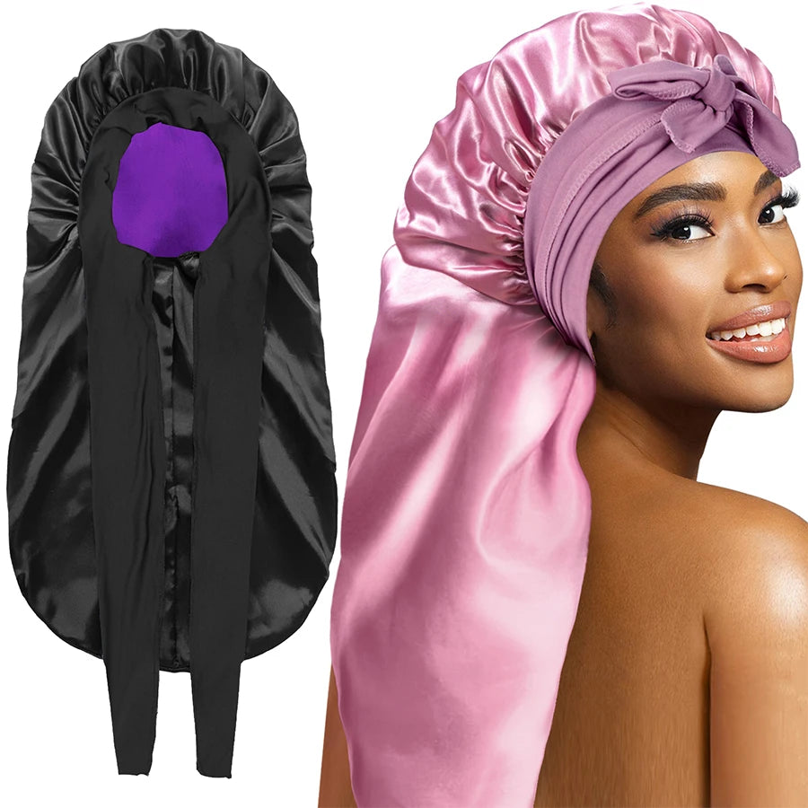 Black satin bonnet with purple interior and pink satin head wrap worn by a model on a white background