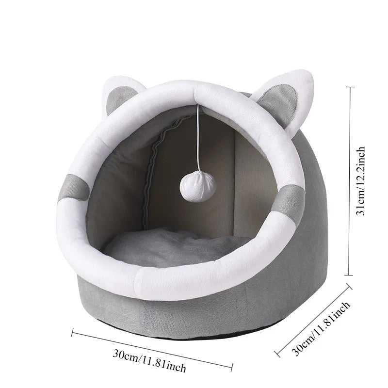 Gray pet bed with white accents and a hanging ball on a white background
