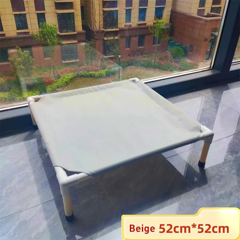 Beige pet bed on a reflective floor with a window view of buildings and greenery.