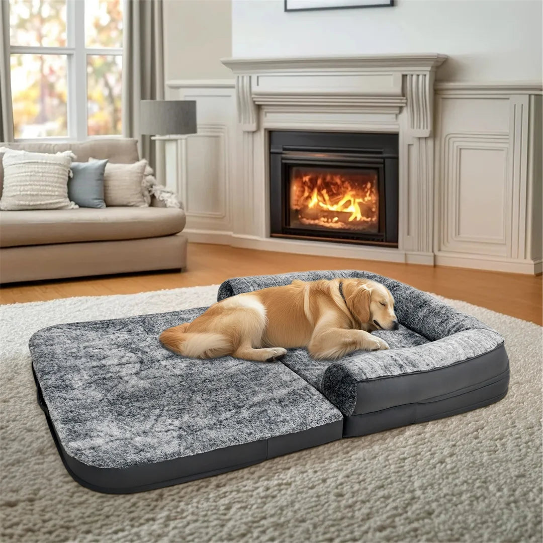 Dog lying on a large pet bed in a cozy living room with a fireplace.