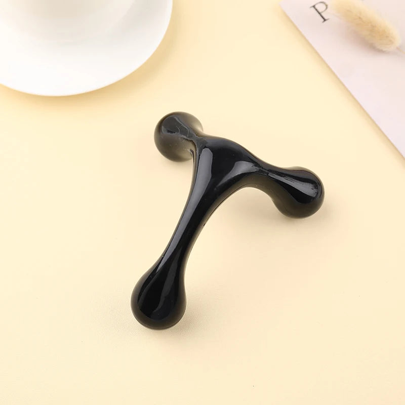 Black T-shaped object on a beige background