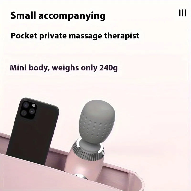 Small massage device next to a smartphone on a pink stand with text about its weight and portability.