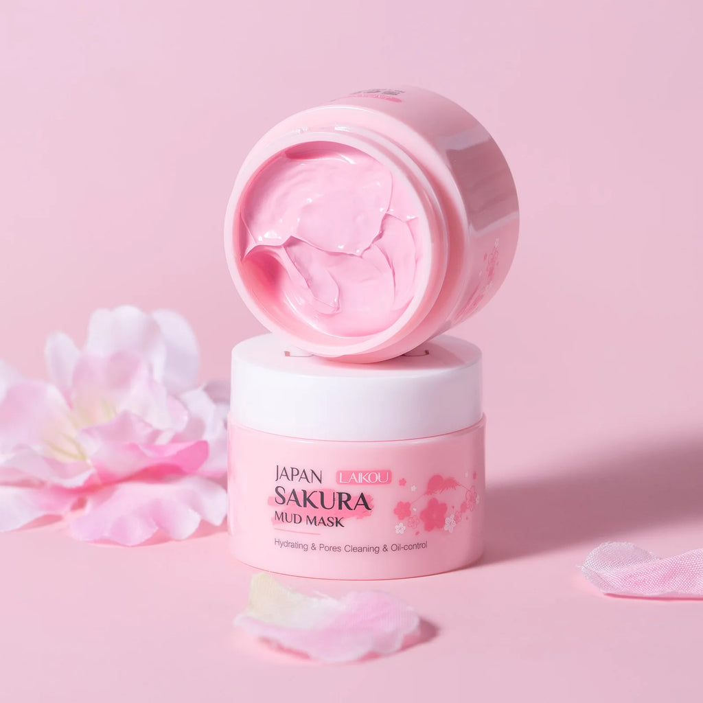 Pink mud mask jar with open lid on a pink background