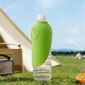 Green water bottle with a camping scene in the background