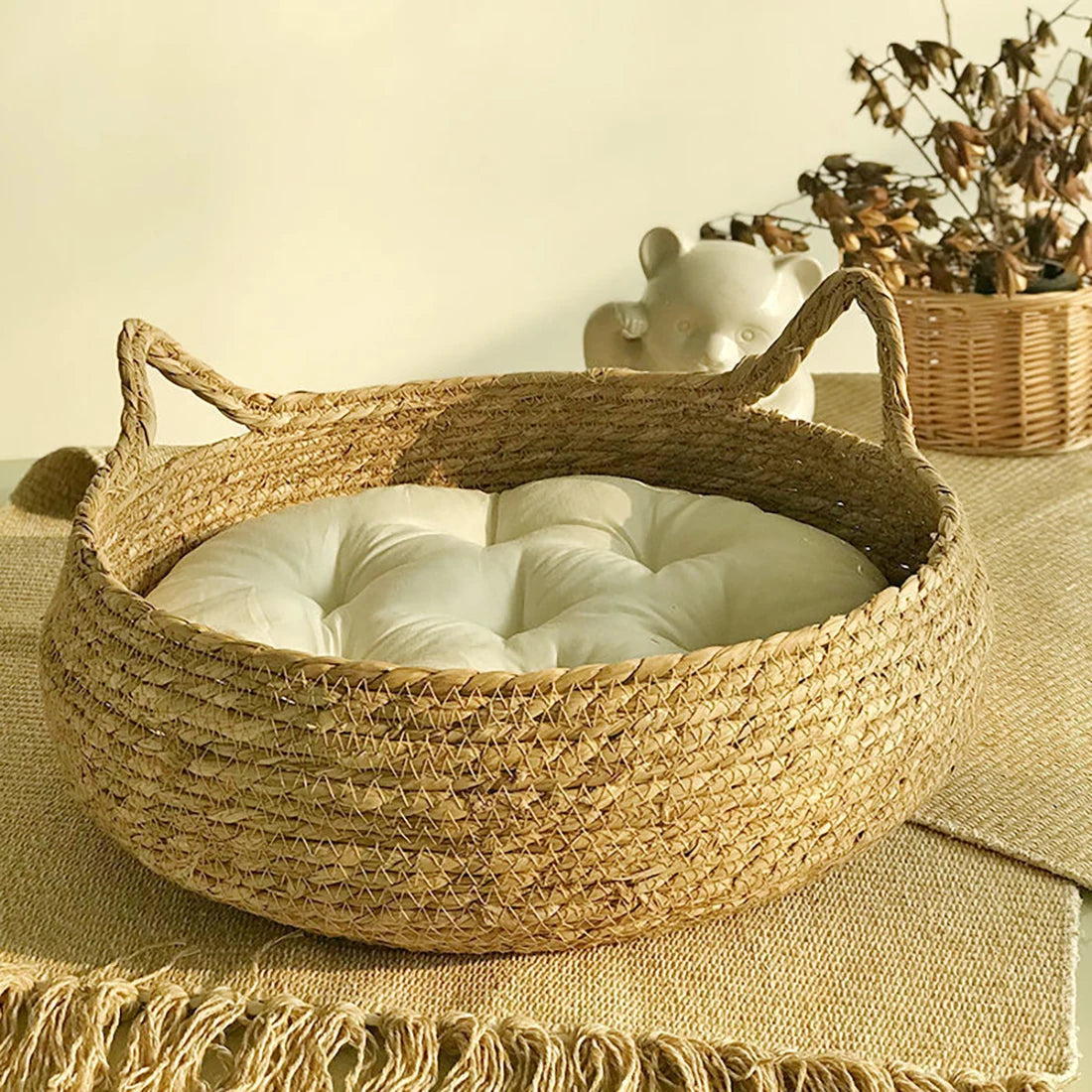 Woven basket with a white cushion on a textured surface with a neutral background