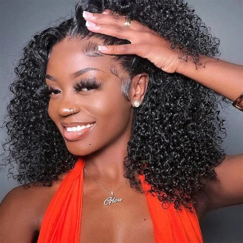 Woman with styled hair wearing an orange top against a gray background