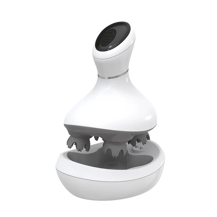 A white and gray electric head massage device with a matching charging base, shown on a plain white background. A 'FLANIQUE NEW ARRIVAL' promotional badge is in the top-left corner, and 'ELANIQUE.