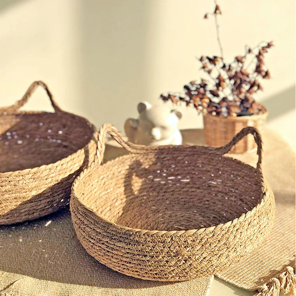 Two woven baskets on a textured surface with a blurred background