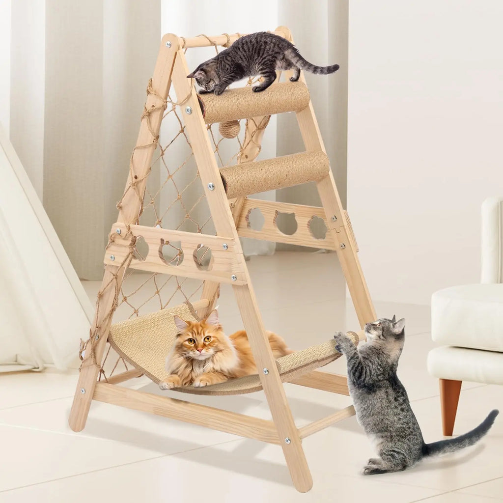 Three cats on a wooden cat tree with hammock in a room.