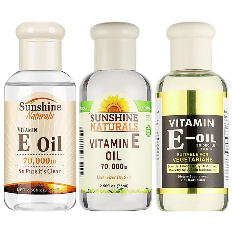 Three bottles of Sunshine Naturals Vitamin E Oil on a white background